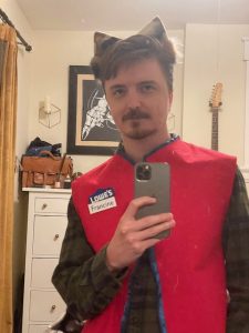 Mirror selfie; I'm wearing a Lowe's vest with a "Francine" nametag, and cat ears.