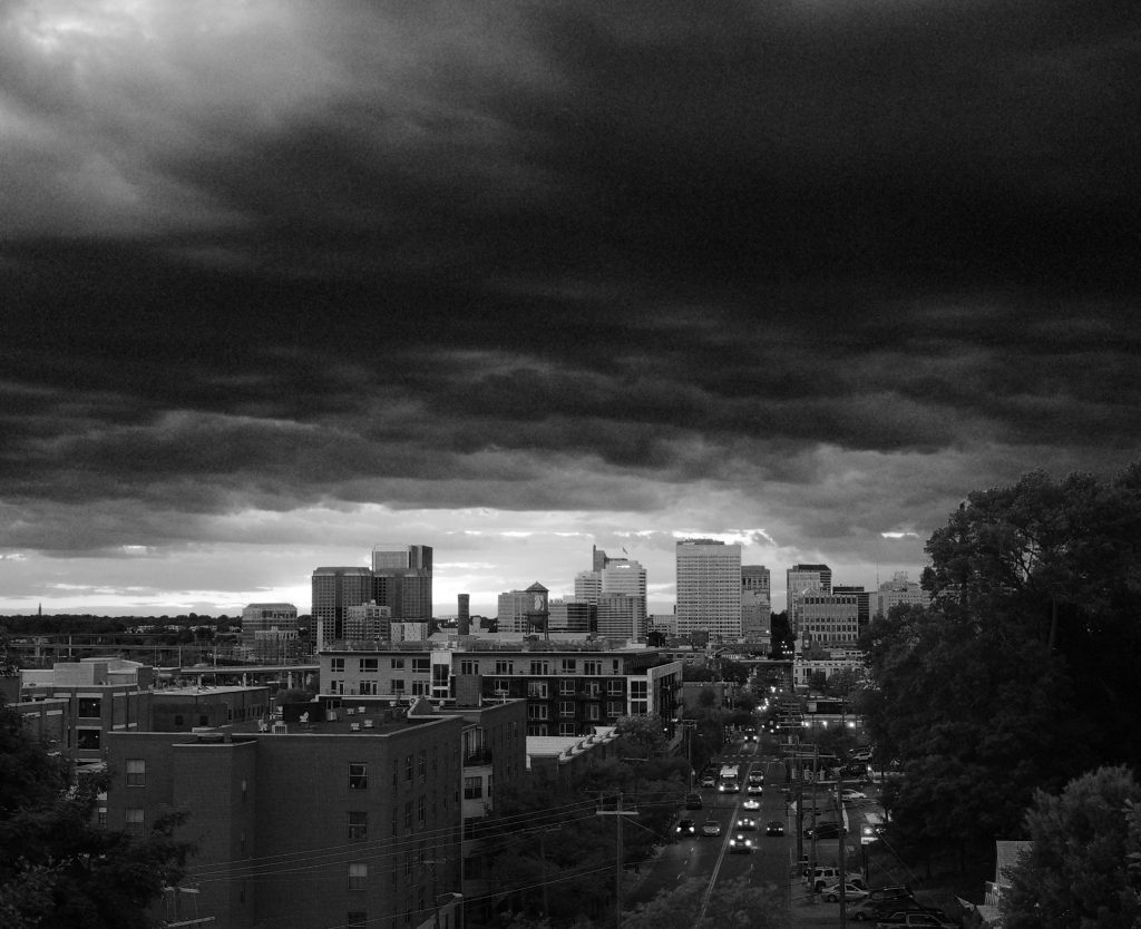 Greyscale image of storm clouds over downtown Richmond, as seen from Libby Hill.